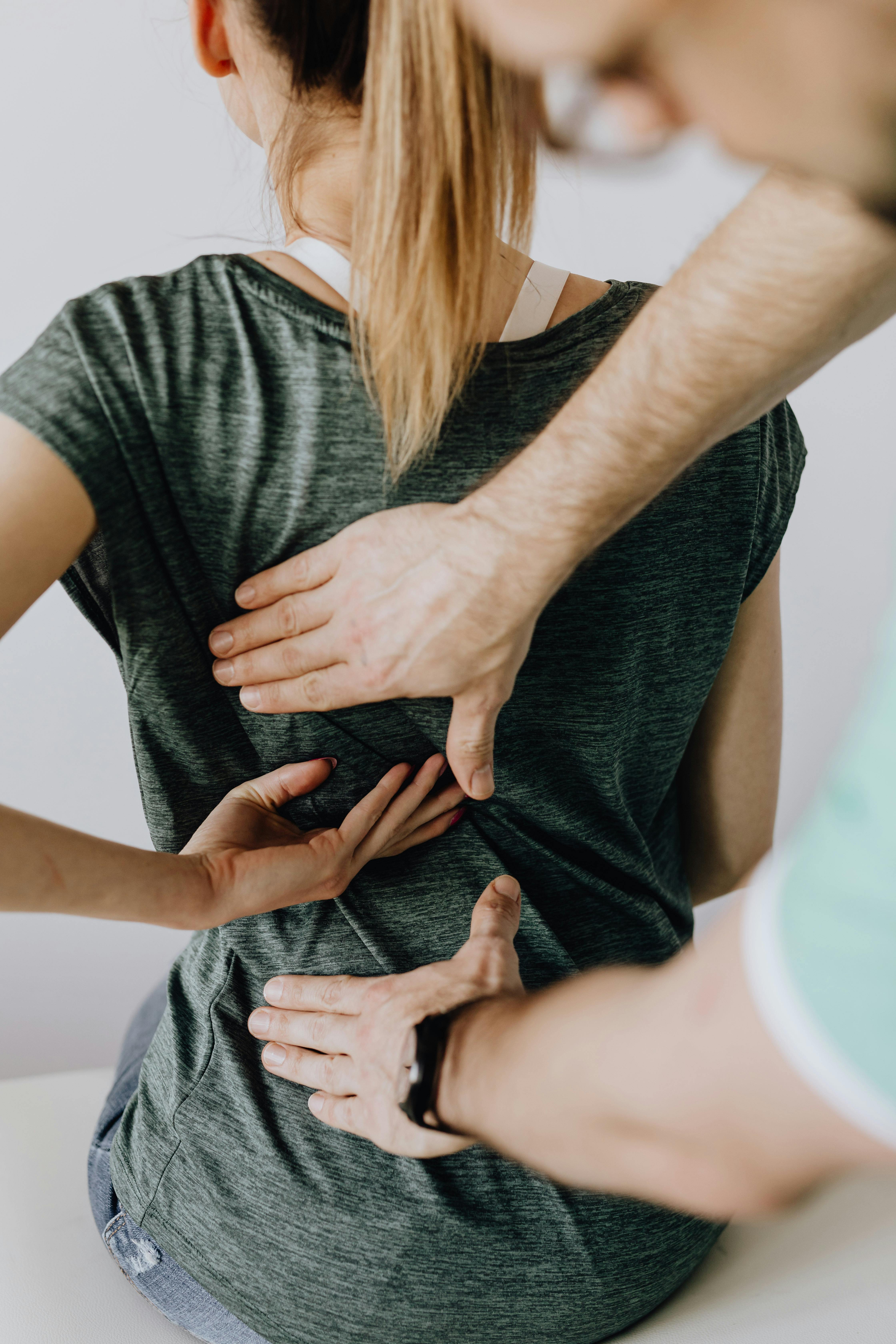 Physiotherapist providing back support treatment